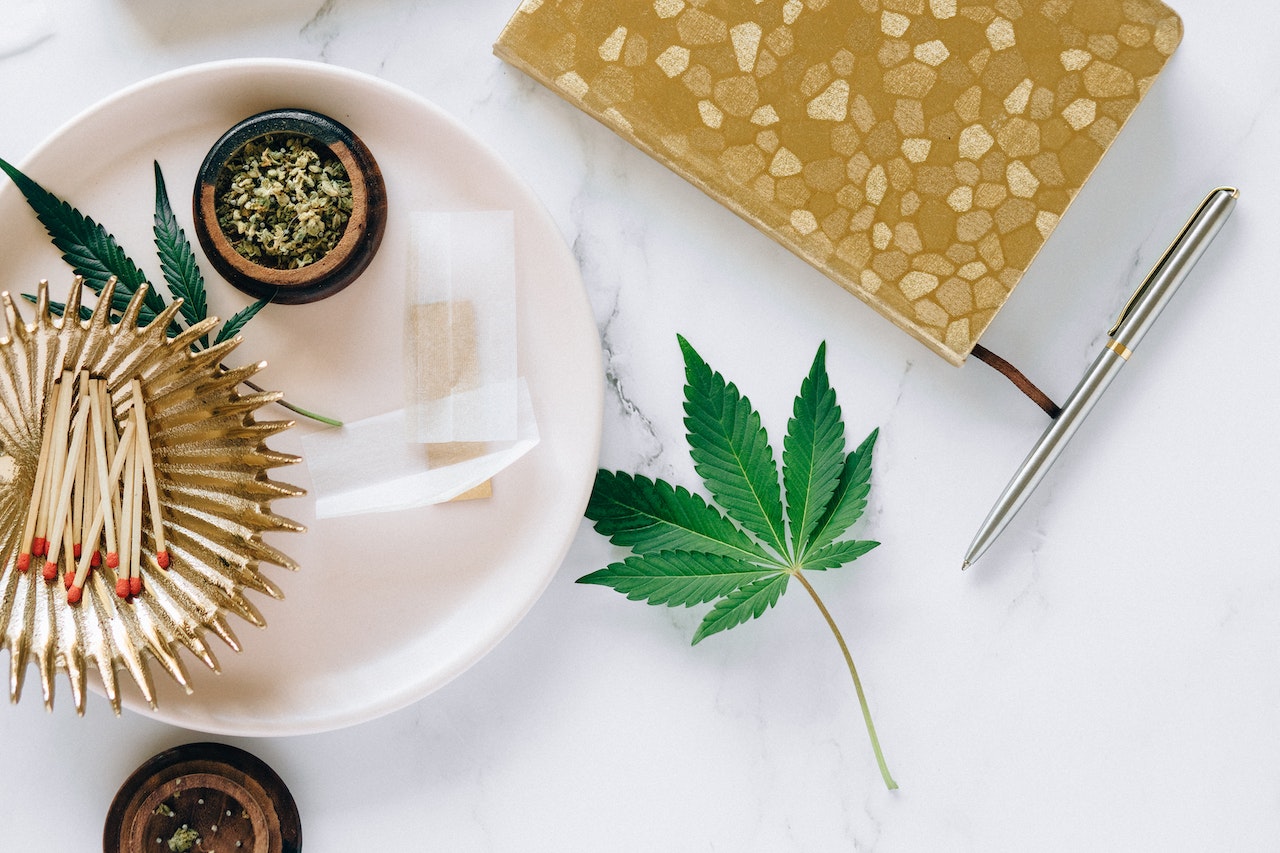 Cannabis leaf and other products on a white countertop