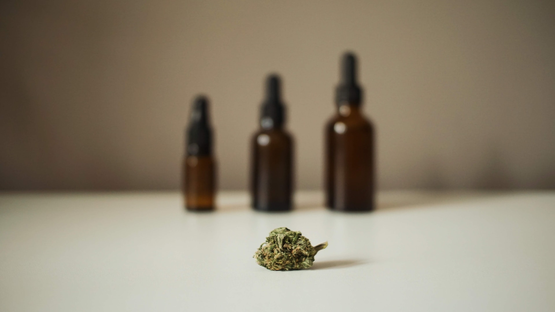 Weed bud in front of weed tinctures